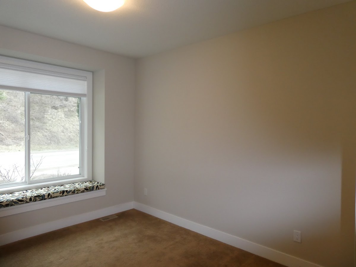 Bright bedroom finished in a clean taupe